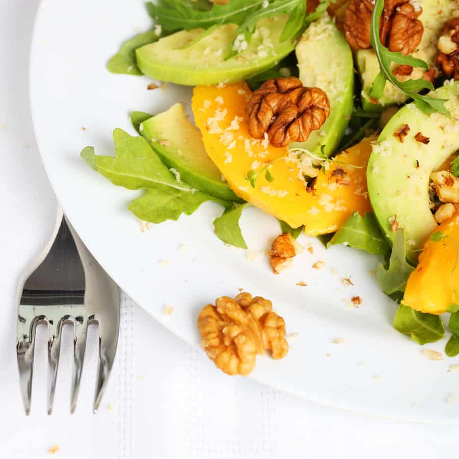 Looseleaf lettuce topped with mango and avocado