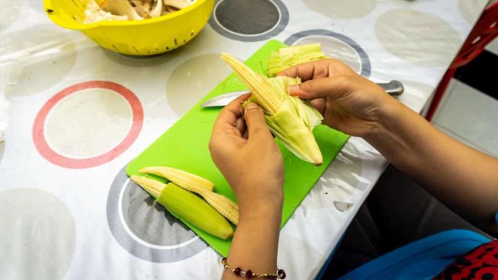 Husking baby corn