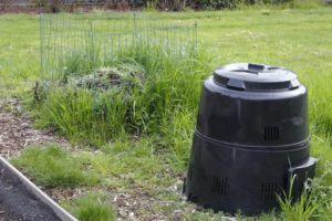 Compost pile in wire cage and compost bin