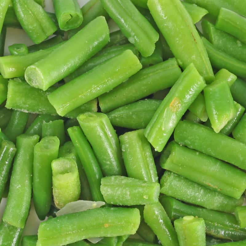 Cut green beans into short pieces for canning.