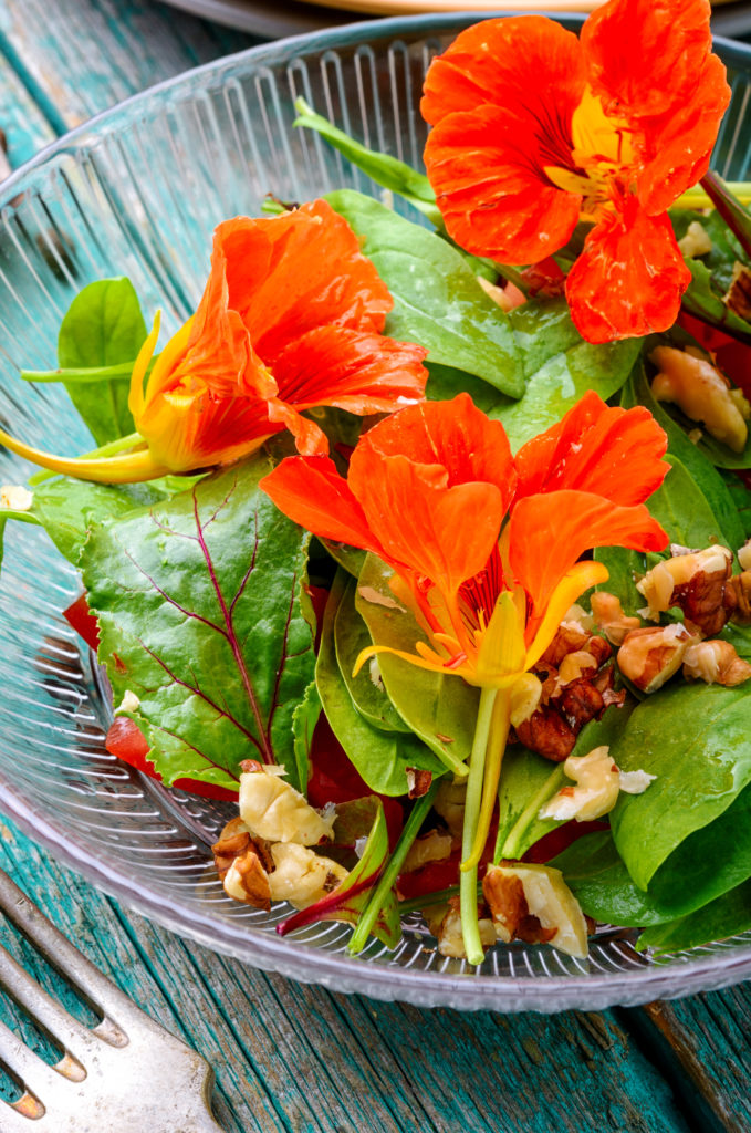 Nasturtium flowers, leaves, tomatoes, and nuts