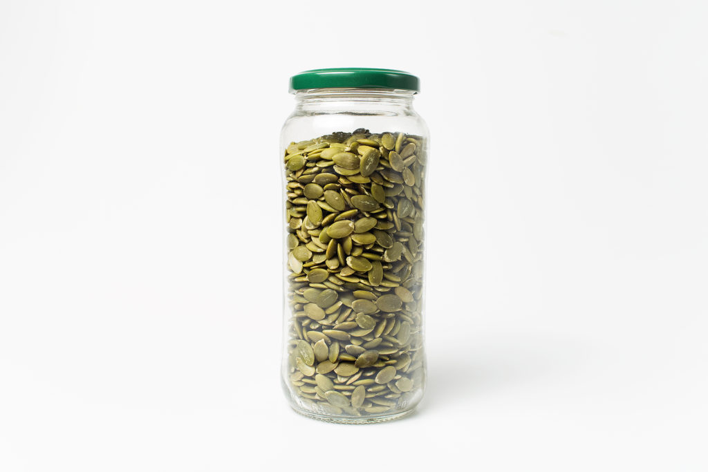 Pumpkin seeds stored in a glass jar